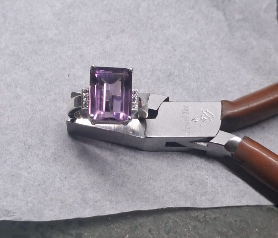 Completed ring featuring a securely set gemstone and a high-shine polished finish