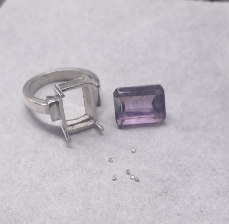 Ring with unset gemstone and a dull, unfinished surface awaiting final setting and polish