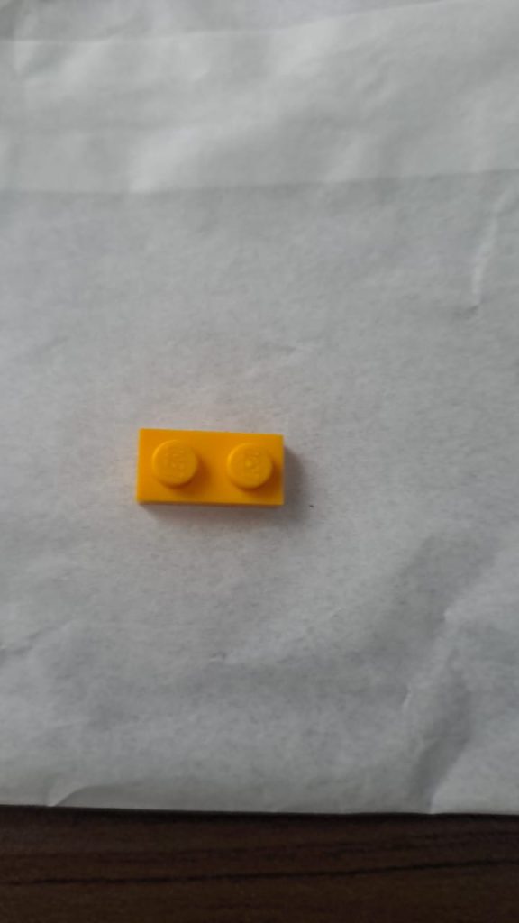 Plastic LEGO piece in its original form before being transformed into a custom jewellery pendant